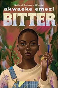 The cover of Bitter, by Akwaeke Emezi. There is a young woman of African decent with close-cropped hair and elegant eyebrows. She has dark mauve lipstain and has a silver lip piercing on the lower left. She is dressed in striped Liberty-type overalls with a paint-bespattered pale yellow sweatshirt underneath. In her left hand she holds a purple paintbrush tipped in gold paint, raised up, pointing out of the top of the image. The backdrop she stands in front of is colored in bright swaths of paint - dark green and light, splotches of white and bright pink.